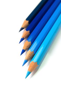 An assortment of blue color pencils on white background
