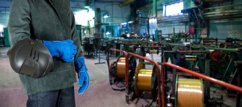 Worker welder with instruments at industrial factory