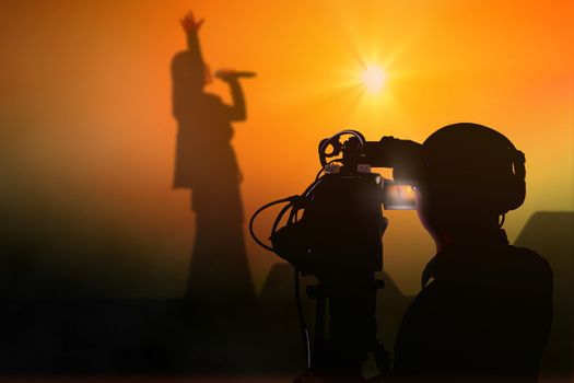 Cameraman shooting a live concert on stage