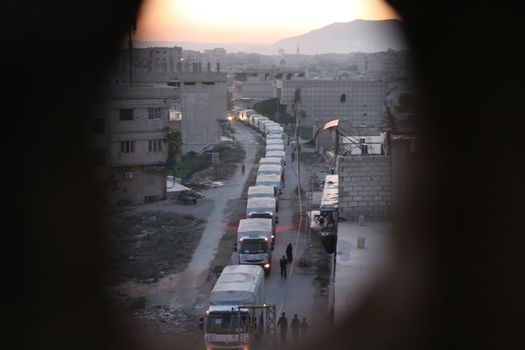 SYRIA, Saqba: Syrian Arab Red Crescent lorries carrying aid sent by the United Nations in the town of Saqba, in the eastern Ghouta area, a rebel stronghold east of the Syrian capital Damascus, on April 19, 2016.