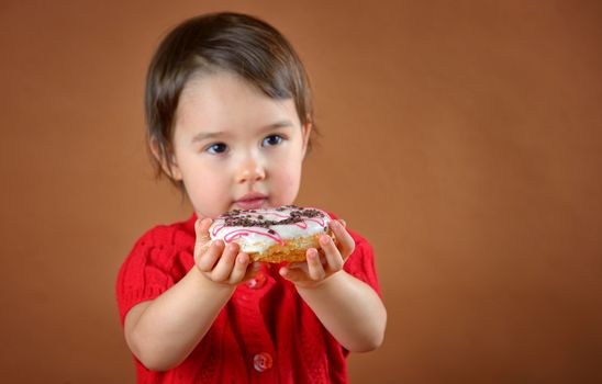 little girl holding donuts shoot in studio