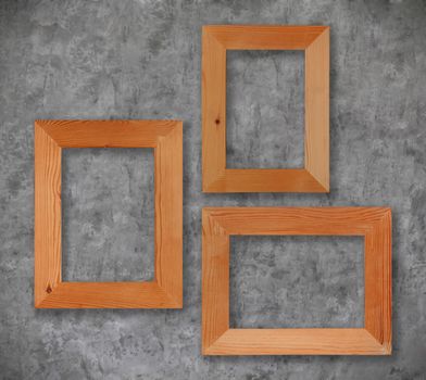 Group wooden frames on the cement wall