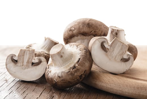 raw natural mushrooms champignon on a wooden board