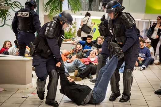 FRANCE, Toulouse: Policemen evacuate an activist who occupies a BNP bank branch to protest against tax haven, in Toulouse, southern France, on April 20, 2016.