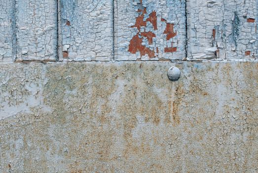 the door of planks covered with sheets of rusty metal, chipped old paint, which has long been under the influence of various climatic conditions