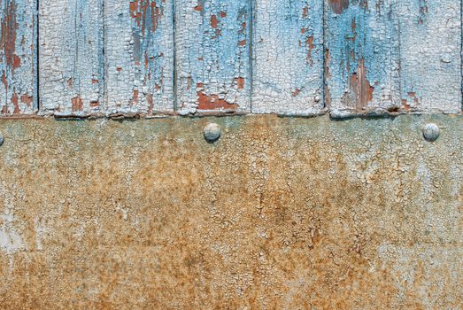 the door of planks covered with sheets of rusty metal, chipped old paint, which has long been under the influence of various climatic conditions