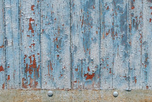 the door of planks, chipped old paint, which has long been under the influence of various climatic conditions