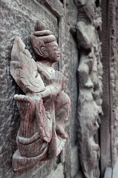 MANDALAY,MYANMAR-APR 19 : Carved wooden figure at Shwenandaw Monastery (Golden Palace Monastery) in Mandalay, Myanmar. Golden Palace Monastery was built in 1880 (The traditional Burmese architectural style)  on April 19,2013,Mandalay city in Myanmar.