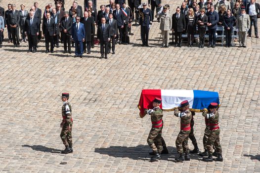 FRANCE, Paris : Soldiers carry three coffins drapped with the French national flag with the bodies of three French soldiers killed in service in Mali last week, during a solemn and national tribute ceremony at the Hotel des Invalides in Paris, on April 20, 2016.Three French peacekeeping soldiers died after their armoured car ran over a landmine in Mali, the French presidency said April 13, 2016. One soldier, Mickael Poo-Sing, was killed immediately in the blast on April 12, 2016 and President Francois Hollande learned with great sadness that two more soldiers had died in the west African country, a statement said. The car was leading a convoy of around 60 vehicles travelling to the northern desert town of Tessalit when it hit the mine, according to the French defence ministry. The troops were part of Operation Barkhane, under which France has some 3,500 soldiers deployed across five countries in the Sahel region, south of the Sahara desert, to combat the jihadist insurgency raging there.