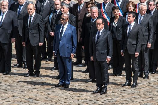 FRANCE, Paris : Malian President Ibrahim Boubacar Keita (front L), French President Francois Hollande (Front R), France Prime Minister Manuel Valls (2rd row back R), French Senate President Gerard Larcher (2rd row back C), French Minister for Education Najat Vallaud-Belkacem (3rd row back C) and French Health Minister Marisol Touraine (3rd row back L), attend a solemn and national tribute ceremony at the Hotel des Invalides in Paris, on April 20, 2016 in honour of the three French soldiers killed in service in Mali last week.Three French peacekeeping soldiers died after their armoured car ran over a landmine in Mali, the French presidency said April 13, 2016. One soldier, Mickael Poo-Sing, was killed immediately in the blast on April 12, 2016 and President Francois Hollande learned with great sadness that two more soldiers had died in the west African country, a statement said. The car was leading a convoy of around 60 vehicles travelling to the northern desert town of Tessalit when it hit the mine, according to the French defence ministry. The troops were part of Operation Barkhane, under which France has some 3,500 soldiers deployed across five countries in the Sahel region, south of the Sahara desert, to combat the jihadist insurgency raging there. 