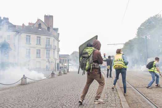 FRANCE, Nantes : Protesters face riot police on April 20, 2016 in Nantes, western France, as they protest against the government's planned labour law reforms.High school pupils and workers protest against deeply unpopular labour reforms that have divided the Socialist government and raised hackles in a country accustomed to iron-clad job security.