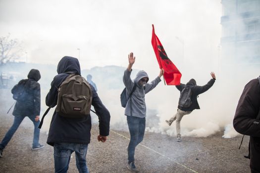 FRANCE, Nantes: Protesters run away from tear gas thrown by riot police as hundreds demonstrate against the French government's proposed labour law reforms on April 20, 2016 in Nantes, western France. High school pupils and workers protest against deeply unpopular labour reforms that have divided the Socialist government and raised hackles in a country accustomed to iron-clad job security.