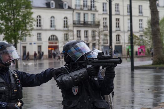 FRANCE, Nantes : Riot police face protesters on April 20, 2016 in Nantes, western France, as they protest against the government's planned labour law reforms.High school pupils and workers protest against deeply unpopular labour reforms that have divided the Socialist government and raised hackles in a country accustomed to iron-clad job security.