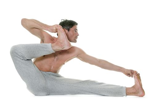 man doing yoga in front of white background