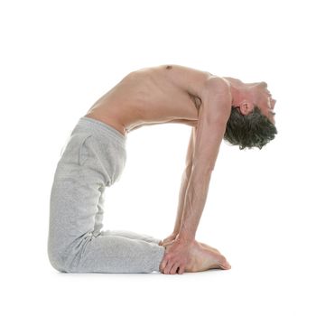 man doing yoga in front of white background