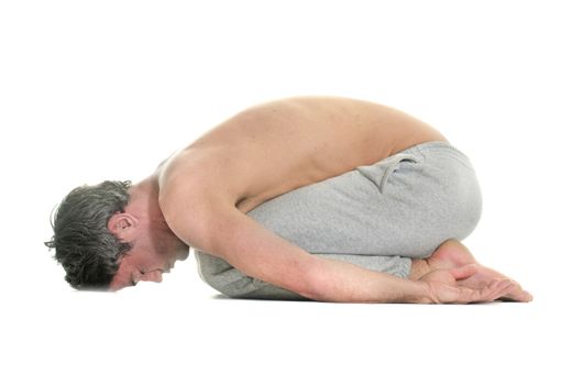 man doing yoga in front of white background