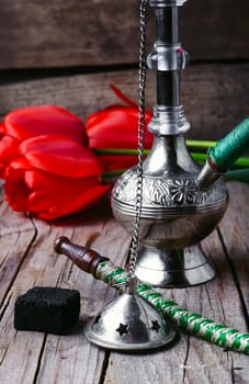 Stylish metal Arabic shisha and a bunch of tulips