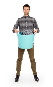 Full length portrait of a young man holding a laundry basket isolated on white background