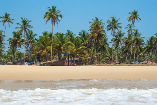 Kolva, India - April 20, 2016: Goan beach panorama with sea, fisherman boats and palms