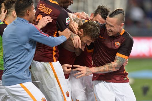 ITALY, Rome: Francesco Totti with his teammates of AS Roma celebrates after scoring the team's third goal from penalty spot during the Serie A match between AS Roma and Torino FC at Stadio Olimpico on April 20, 2016 in Rome, Italy.