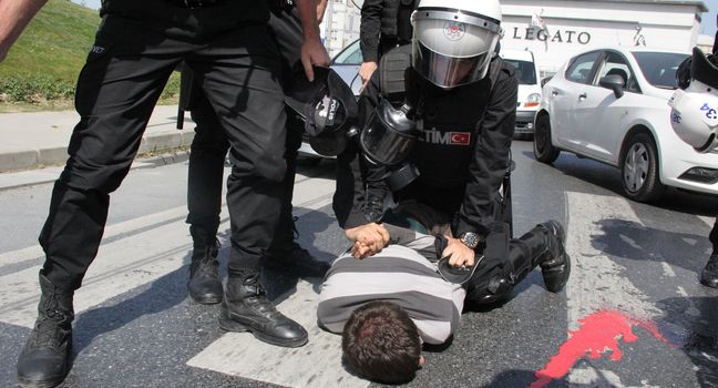 TURKEY, Istanbul: A policeman arrests a protester outside the courthouse in Istanbul, Turkey, on April 20, 2016, during the second hearing in the trial of a police officer accused of killing Dilek Doğan. Dogan died after being shot dead during a police raid of her family's house in Istanbul's Sariyer district, last October. Dozens of protesters, who shouted Murderers of Dilek must be tried, has been taken into custody by police. 