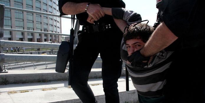 TURKEY, Istanbul: Policemen arrest a protester outside the courthouse in Istanbul, Turkey, on April 20, 2016, during the second hearing in the trial of a police officer accused of killing Dilek Doğan. Dogan died after being shot dead during a police raid of her family's house in Istanbul's Sariyer district, last October. Dozens of protesters, who shouted Murderers of Dilek must be tried, has been taken into custody by police. 