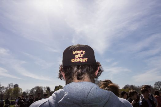 UNITED-KINGDOM, London: A man wears a cap reading Don't get caught as hundreds of pro-cannabis supporters gather in Hyde Park, in London for 4/20 day, a giant annual smoke-in  on April 20, 2016. 