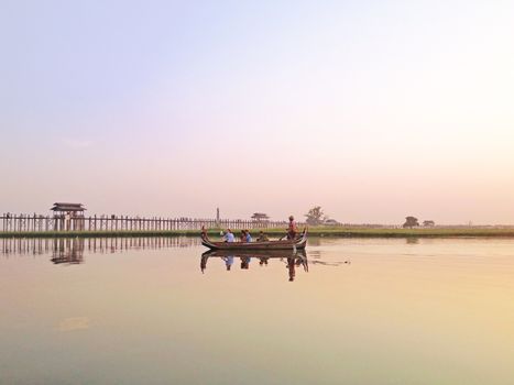 Sunset U Bein Bridge, Myanmar-21 APRIL2013:Sightseeing at U Bein bridge, Lake in Amarapura, Mandalay, Myanmar. U Bein bridge is the oldest and longest teakwood bridge in the world.