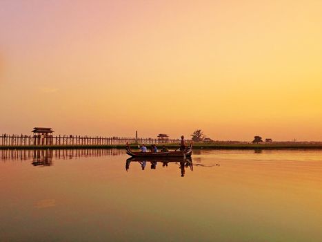 Sunset U Bein Bridge, Myanmar-21 APRIL2013:Sightseeing at U Bein bridge, Lake in Amarapura, Mandalay, Myanmar. U Bein bridge is the oldest and longest teakwood bridge in the world.