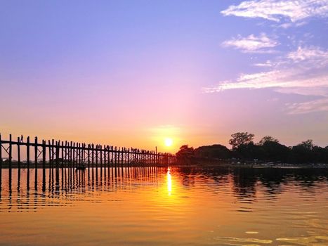 Sunset U Bein Bridge, Myanmar-21 APRIL2013:Sightseeing at U Bein bridge, Lake in Amarapura, Mandalay, Myanmar. U Bein bridge is the oldest and longest teakwood bridge in the world.