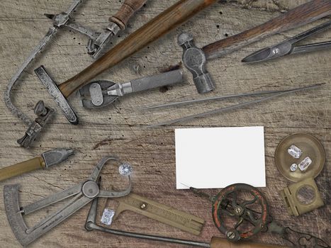  vintage jeweler tools and diamonds over wooden bench, space for your business name