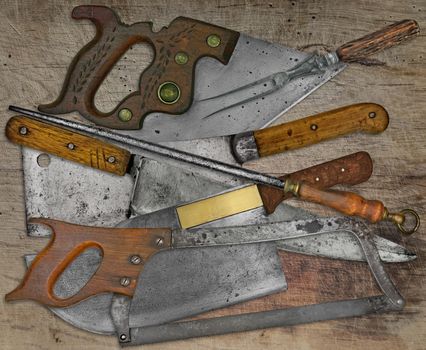 vintage butcher shop tools and utensils over stained wooden table