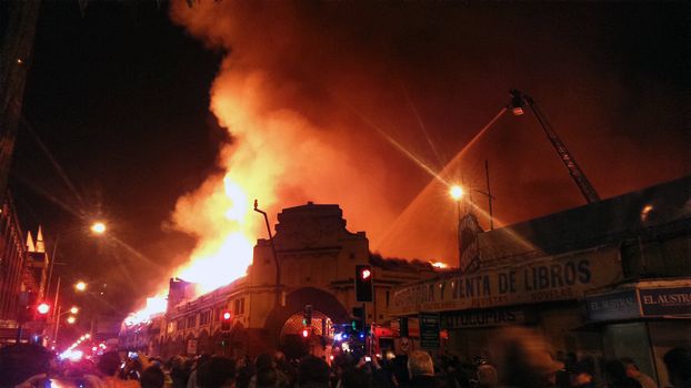 CHILE, Temuco: A massive fire hits the municipal market of Temuco, in the Cautin province, southern Chile, on the evening of April 20, 2016. At least two firefighters have been injured as over 400 people worked to evacuate nearby residents.