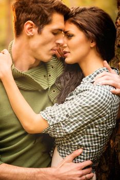 Kiss of beautiful couple in the natural environment. Close-up.