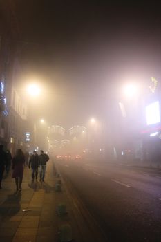 BOSNIA AND HERZEGOVINA, Sarajevo: People walk around Sarajevo, as heavy pollution covers the city on December 24, 2015.Schools were closed in the area due to the hazardous conditions. The city's location in a valley reduces the air flow and creates smog over the area in the winter months. 