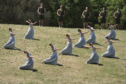 GREECE, Olympia: Actors perform during the lightning ceremony of the Olympic flame at the Temple of Hera on April 21, 2016,  in ancient Olympia, the sanctuary where the Olympic Games were born in 776 BC. The Olympic flame was lit  in an ancient temple in one country in crisis and solemnly sent off carrying international hopes that Brazil's political paralysis will not taint the Rio Games that start in barely 100 days. 