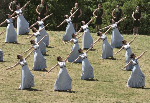 GREECE, Olympia: Actors perform during the lightning ceremony of the Olympic flame at the Temple of Hera on April 21, 2016,  in ancient Olympia, the sanctuary where the Olympic Games were born in 776 BC. The Olympic flame was lit  in an ancient temple in one country in crisis and solemnly sent off carrying international hopes that Brazil's political paralysis will not taint the Rio Games that start in barely 100 days. 