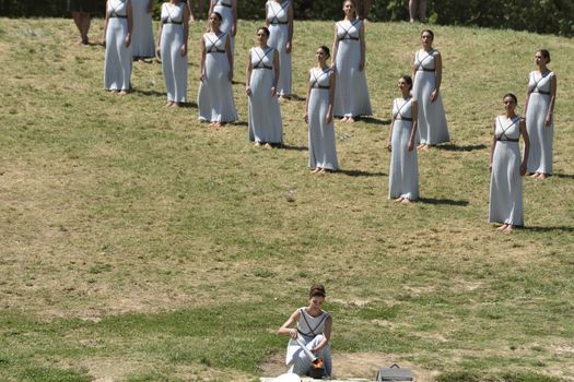 GREECE, Olympia: An actress performing as the priestess holds a pot with the Olympic flame at the Temple of Hera on April 21, 2016, during the lighting ceremony of the Olympic flame in ancient Olympia, the sanctuary where the Olympic Games were born in 776 BC. The Olympic flame was lit  in an ancient temple in one country in crisis and solemnly sent off carrying international hopes that Brazil's political paralysis will not taint the Rio Games that start in barely 100 days. 