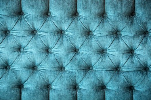 close up of a turquoise velvet sofa