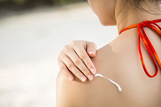 applying sunscreen lotion for protection skin from sunburn