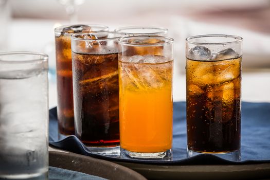 many soft drink are on a tray