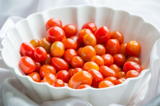 cherry tomato in white bowl on the table