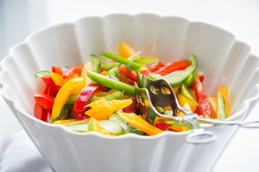 fresh colorful pepper salad in white bowl
