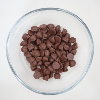 close up of chocolate chips in glass bowl