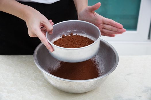 sifting cocoa powder with flour filter