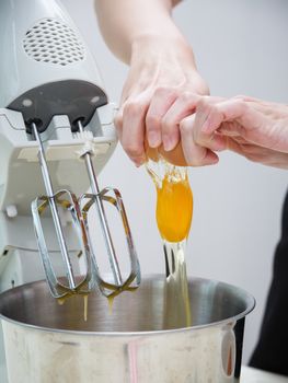breaking egg to the mixing machine