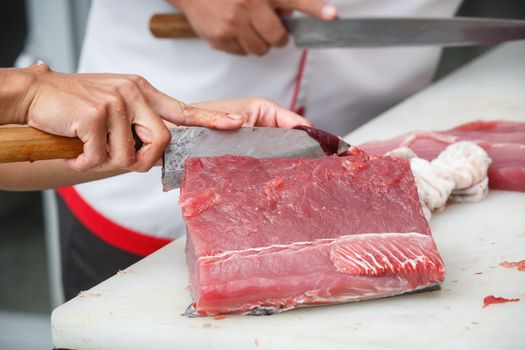 cutting tuna on a white table