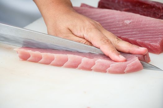 cutting tuna on a white table