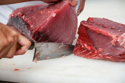 cutting tuna on a white table