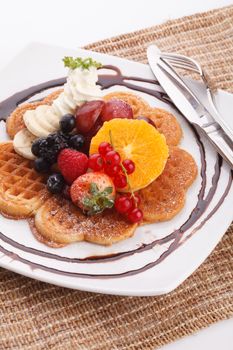 waffle with fresh fruit topping with maple syrup